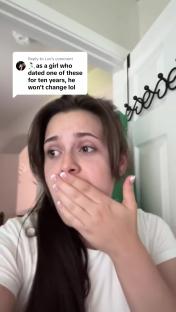 Woman covering her mouth, looking distressed.
