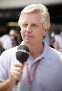 Steve Ryder, ITV Formula One commentator, holding a microphone.
