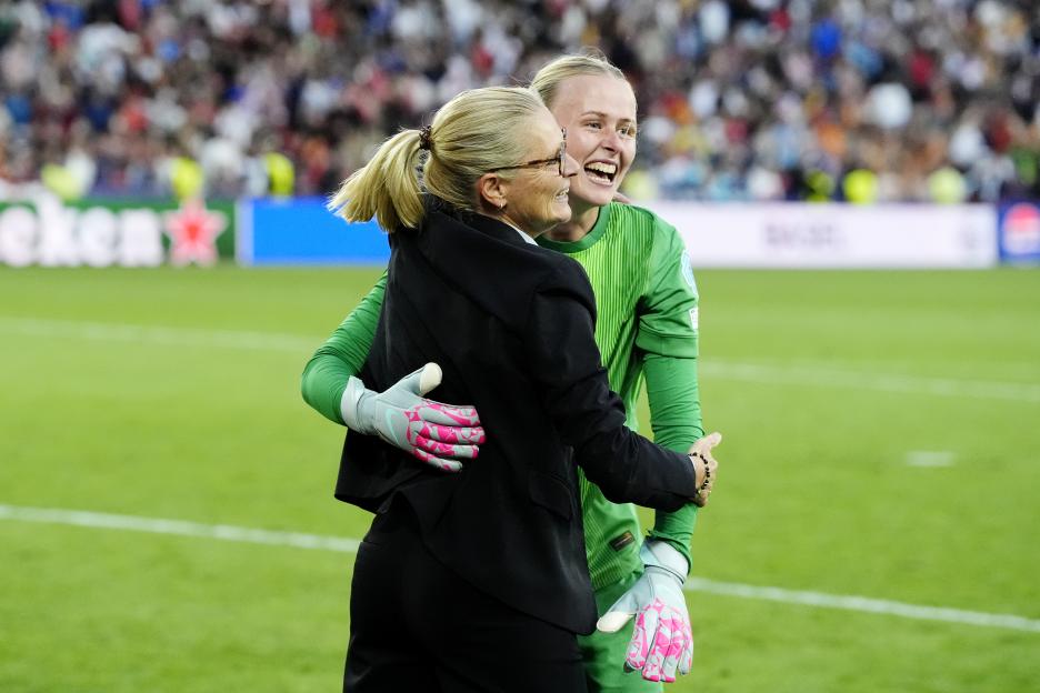 England's goalkeeper and manager celebrating a UEFA Women's Euro win.