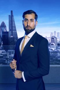 Portrait of Dr. Asif Munaf, a contestant on The Apprentice, in a suit against a London cityscape.