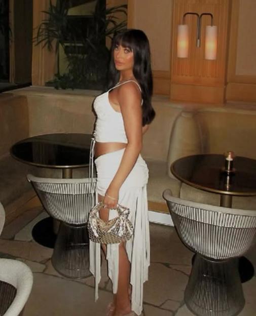 Woman in white outfit sitting in a restaurant.