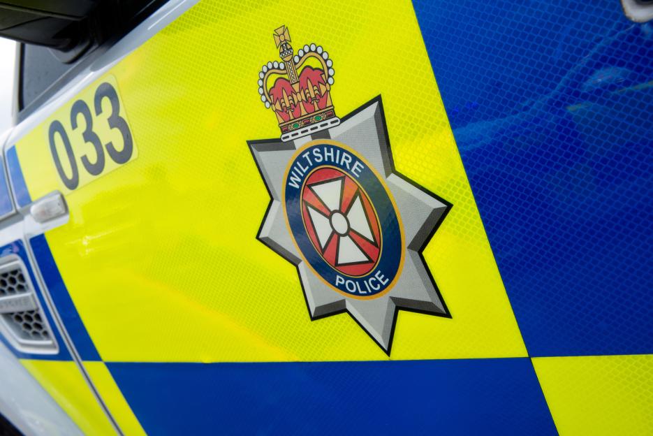 Wiltshire Police insignia on a police car.
