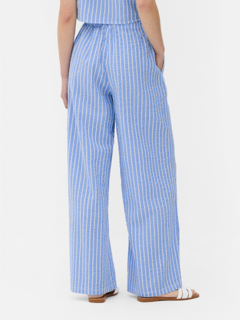 Back view of blue and white striped wide-leg pants.