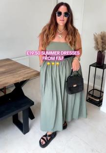 Woman in sage green summer dress and sunglasses.