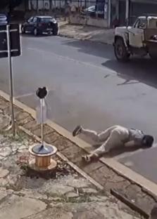 A person tumbling on the ground after jumping from a moving car.