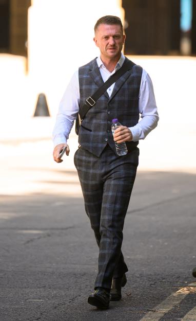 Stephen Yaxley-Lennon walking down a street.