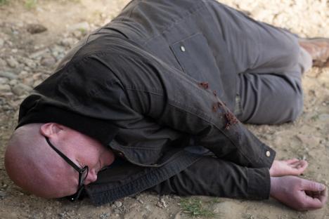 A man lies injured on the ground.
