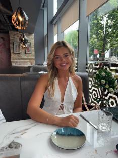 Woman sitting at a restaurant table.