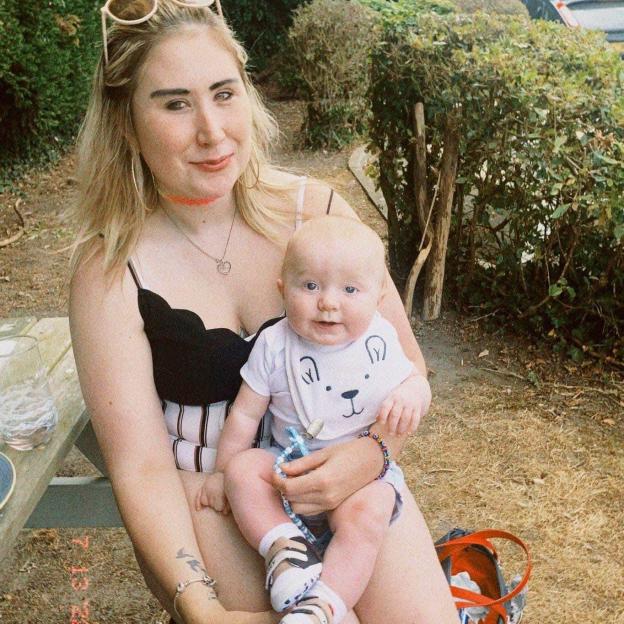 A woman holding a baby on her lap.