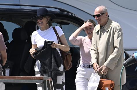 Daniel Day-Lewis and Rebecca Miller arriving by van at a port.