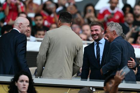 Gianni Infantino, Ronaldo, David Beckham, and Roberto Baggio at a Club World Cup match.