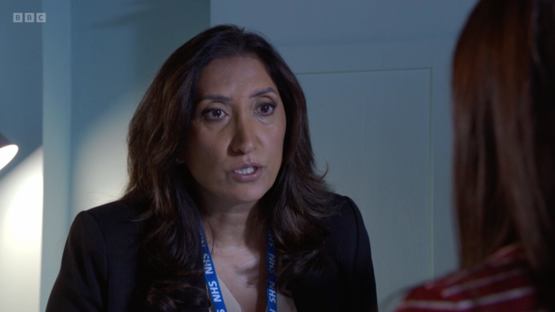 Screenshot of a woman speaking to someone.