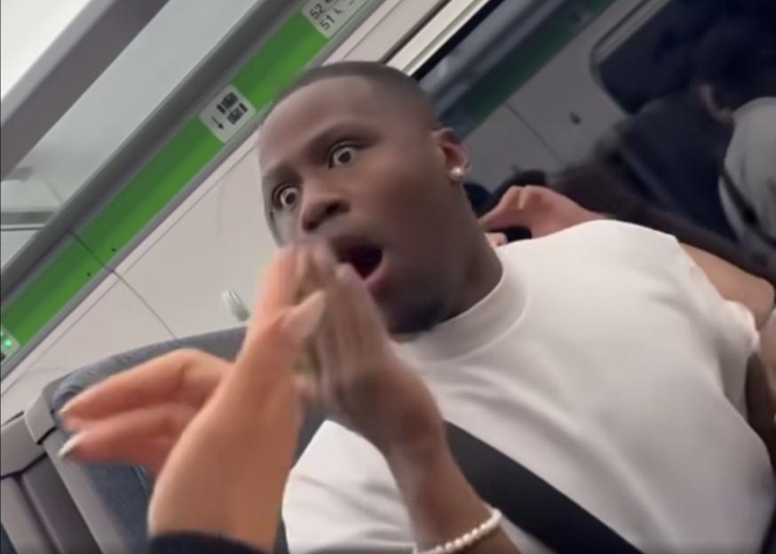 Screenshot of a man on a train yelling at women.