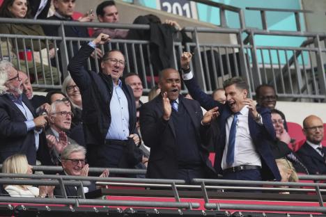 Crystal Palace directors celebrating at a soccer match.