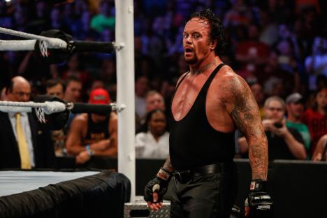NEW YORK, NY - AUGUST 23: The Undertaker recovers during his fight against Brock Lesner at the WWE SummerSlam 2015 at Barclays Center of Brooklyn on August 23, 2015 in New York City. (Photo by JP Yim/Getty Images)
