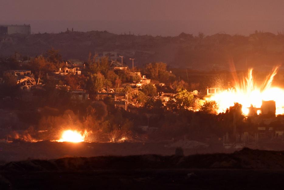 Flames rise in Gaza at night, as seen from Israel.
