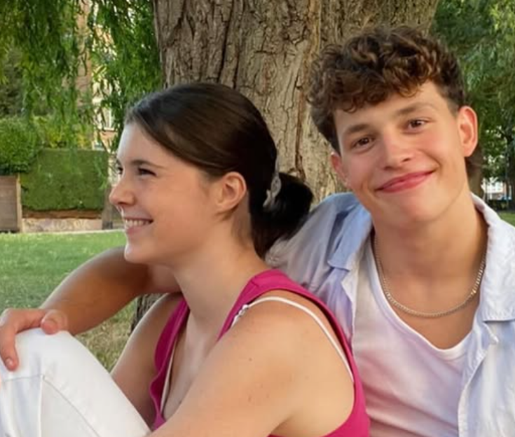 Young couple sitting together outdoors.
