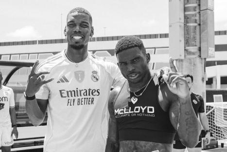 Black and white photo of Paul Pogba and another man.