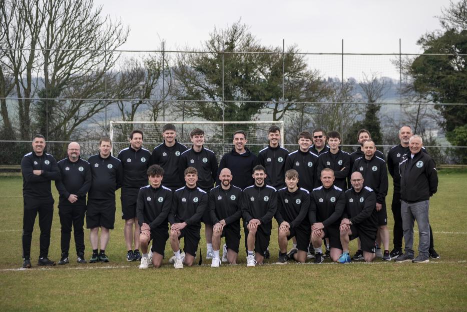 Group photo of a soccer team on a field.