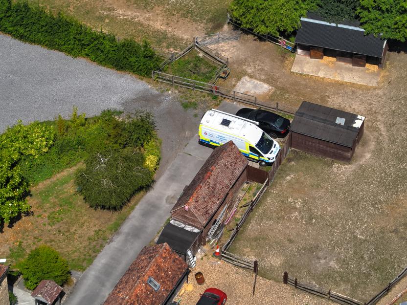 Aerial view of a police van parked at a property.