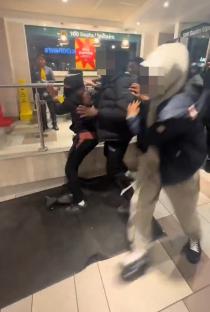 A McDonald's employee slapping a customer during a brawl.