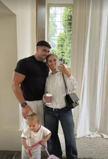 Molly-Mae, Tommy Fury, and their baby taking a selfie.