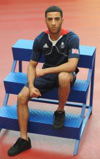 Galal Yafai, a Team GB athlete, sits on a blue step.