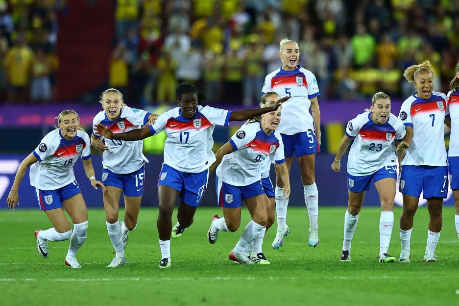 England's women's football team celebrates a victory.