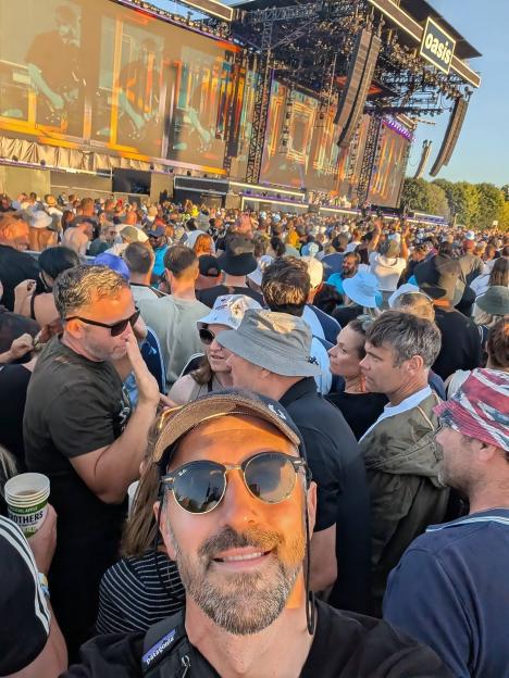Oasis fan at concert in the crowd.
