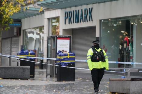 Police officer at a crime scene near a Primark store.
