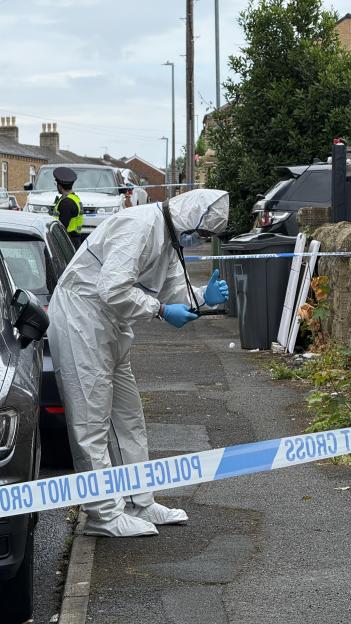 Forensic investigator examining a crime scene.