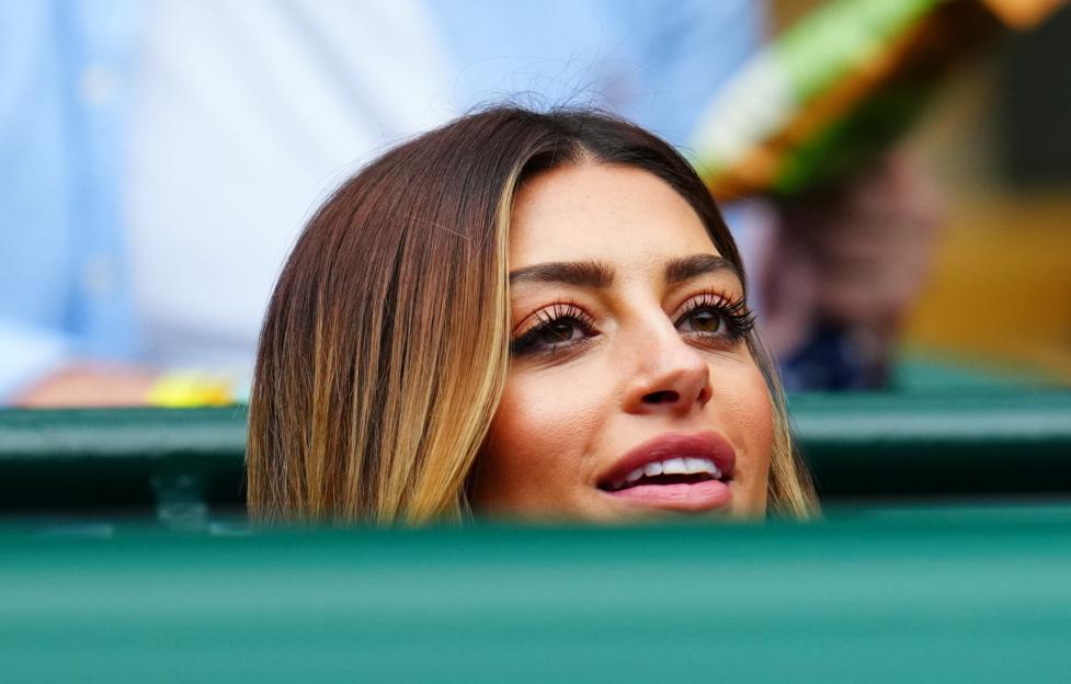 Woman watching a tennis match.
