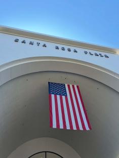 American flag hanging under the archway of Santa Rosa Plaza.