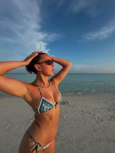 Woman in bikini on beach.