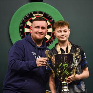 13-year-old Lex Paeshuyse with Luke Littler holding a trophy after winning the PDC World Junior Championship.