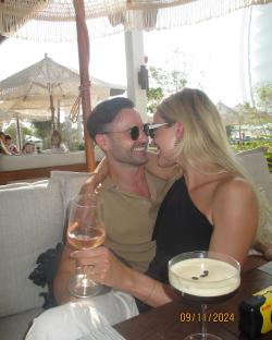 Couple embracing at an outdoor cafe.