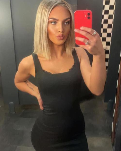 A young woman taking a selfie.