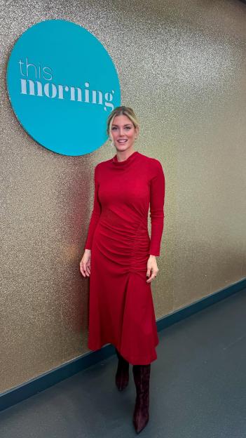 Woman in red dress standing in front of a