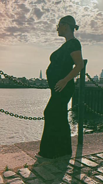 Pregnant Shaughna Phillips by the water.