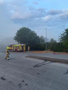 Firefighters battling a large warehouse fire.
