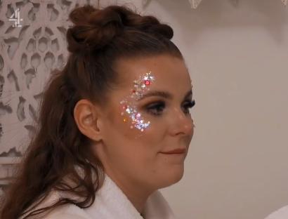 Woman with glitter makeup on her face.