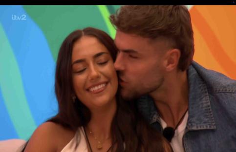 A man kissing a woman on the cheek.