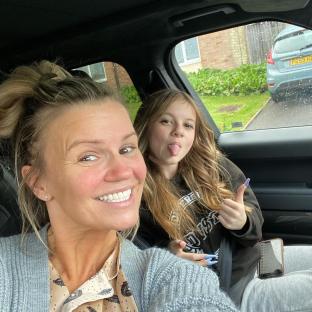 Kerry Katona and her daughter Heidi in a car.