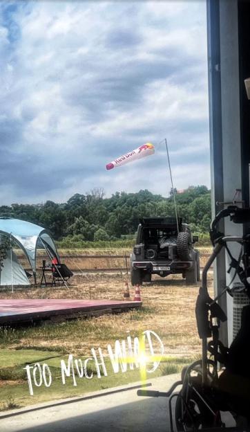 Photo of a Red Bull windsock, a Jeep, and camping equipment; text overlay reads 