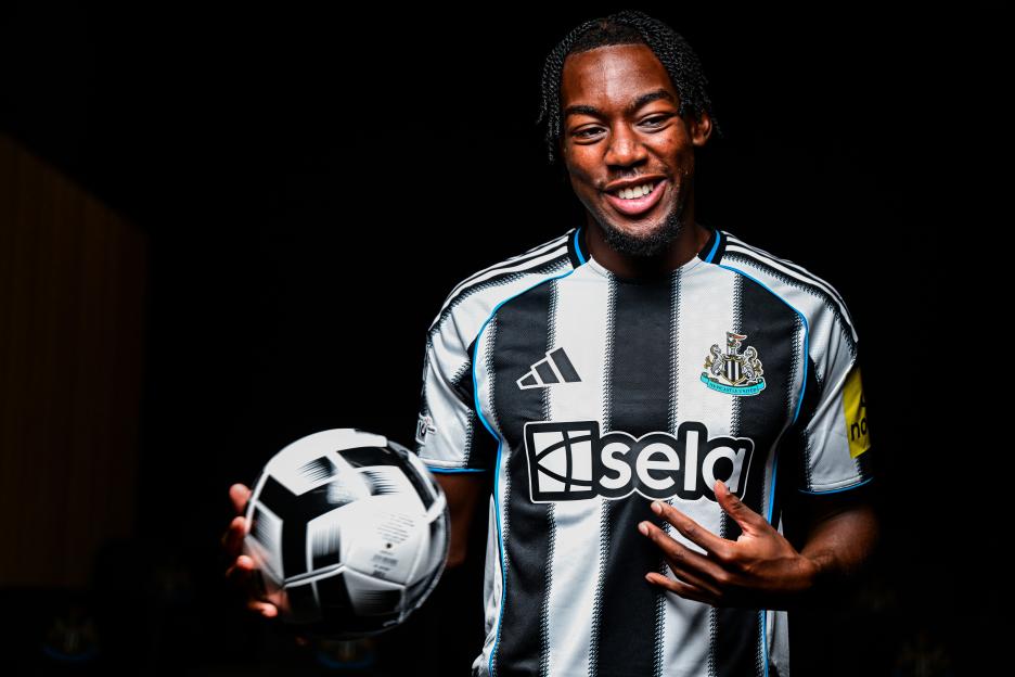 Anthony Elanga in Newcastle United jersey holding a soccer ball.