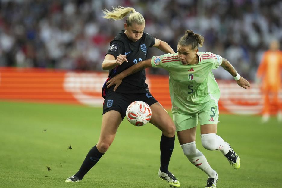 Elena Linari of Italy vying for the ball with Alessia Russo of England during a soccer match.