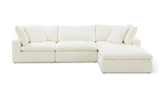 Off-white sectional sofa with pillows.