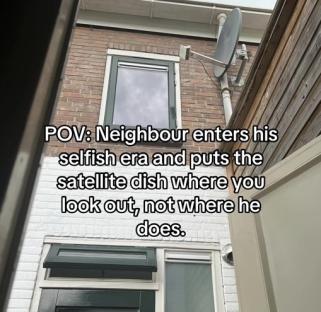Satellite dish obscuring a window view.