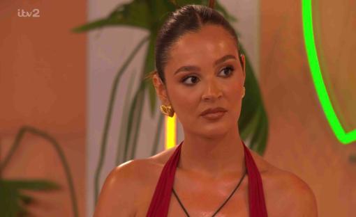 Megan from Love Island in a red halter top.