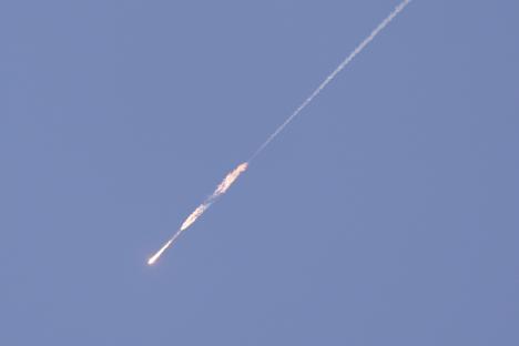 Missile in flight leaving a trail.